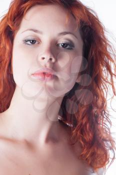 Portrait of beautiful young woman with red hair closeup on white