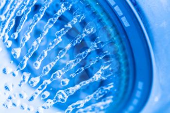 Shower and flying water drops. Shower Head with Running Water, Blue background