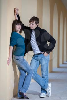 Portrait of a student couple posing outside building in the gallery love relation concept