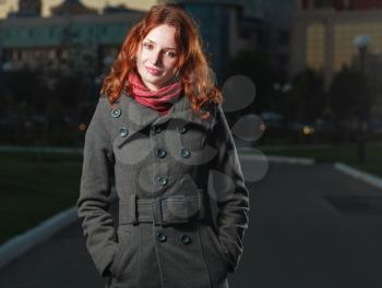 redhead 20s women walk outdoor in autumn park, weared scarf and coat, horizontal shot