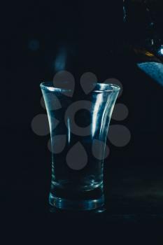 shot glass on black background
