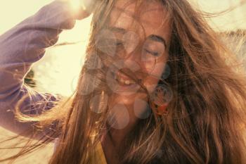 Long haired blonde outdoors on a windy day