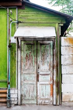 Ancient wooden door in old house wall. Astrakhan, Russia.