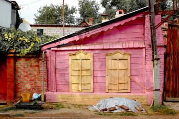 Old painted in pink with yellow windows hut in Astrakhan, Russia