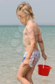 Royalty Free Photo of a Boy Carrying a Bucket