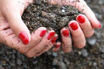 Royalty Free Photo of a Woman Holding Soil