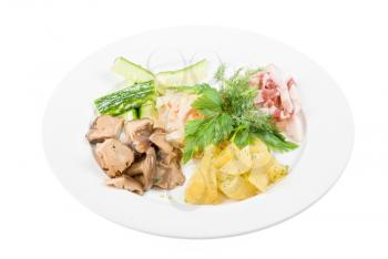 Tasty appetizer: potato, fat and vegetables at plate