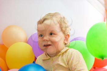 Royalty Free Photo of a Baby Boy Playing With Balloons 