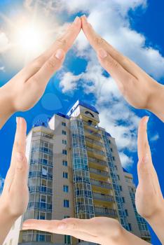 Royalty Free Photo of Hands Around a Building