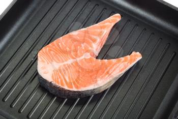 Royalty Free Photo of a Trout Steak on a Grill Pan