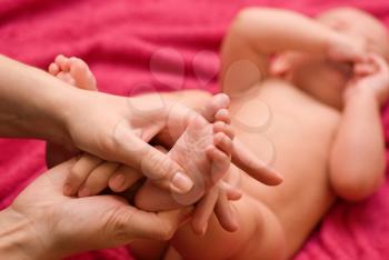 Royalty Free Photo of a Mother Massaging Her Baby's Feet
