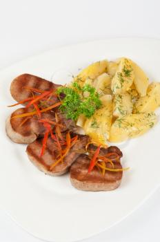 beef tongue with potatoes, carrots and greenery