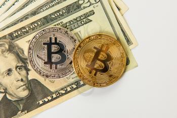 Silver and gold bitcoin coins with dollars on the white background