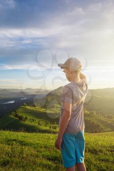 Young explorer at the sunset in Altai mountains