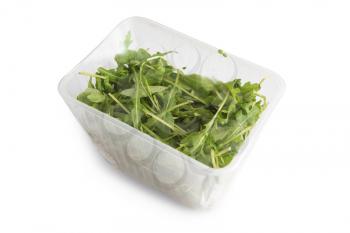 Arugula in plastic bag isolated on a white background