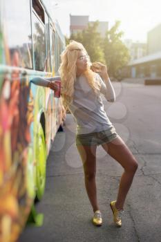 Fast food and leisure concept - beauty young blonde woman eating a burger and soda water