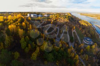 Aerial top vew of winding road in the city, drone shot. Barnaul, Siberia, Russia. Beauty autumn day