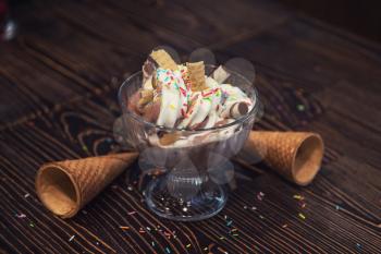Ice-cream on brown wooden background