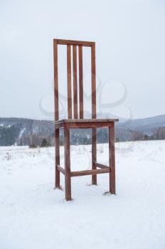 Big wooden chair in Altai mountains in winter
