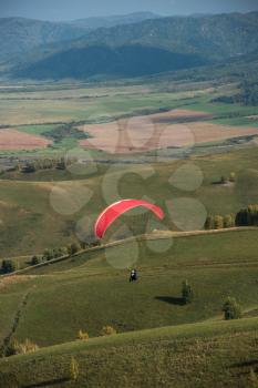 Paragliding in Altai mountains. Paragliders in fight in the mountains, concept of extreme sport activity.