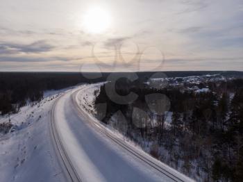 Aerial drone photo of railway in winter forest