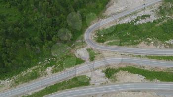 Aerial 4k drone video of top vew of winding road in the mountains, Altai Krai, Western Siberia, Russia. Road to Resort town Belokurikha 2