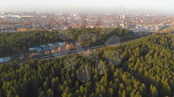 Barnaul, Siberia, Russia - October 13, 2019. Aerial drone footage of train in autumn forest