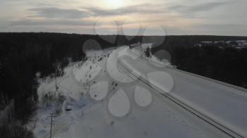 Aerial drone footage of train in winter forest