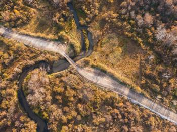 Aerial drone view of autumn landscape with river and bridge