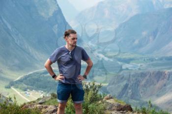 Man on the top of Altai mountain, Katu Yaryk mountain pass and the valley of the river of Chulyshman, beauty summer day landcape. Travel, leisure and freedom concept
