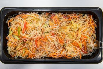 Marinated korean Hwe salad with fish and vegetables in plastic container