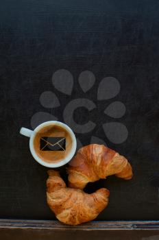 coffee with mail sign and croissant at board
