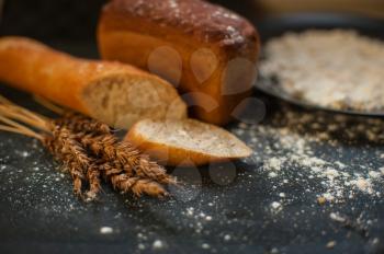 Bread composition with wheats. Very shallow DOF photo and specific art curly bokeh for extra volume.