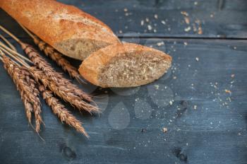 Bread composition with wheats. Very shallow DOF photo and specific art curly bokeh for extra volume.