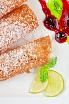 Sicilian cannoli at plate decorated with lime and jam