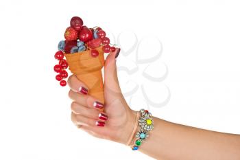 hand holding fresh berries in wafer