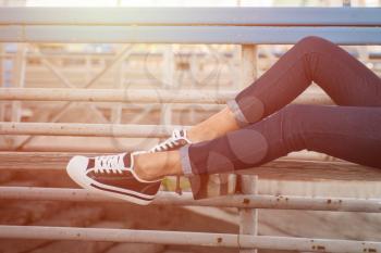 closeup of woman legs in white gumshoes, outdoor shot