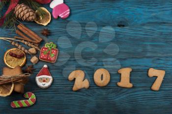 Gingerbreads for new 2017 year on wooden background, xmas theme