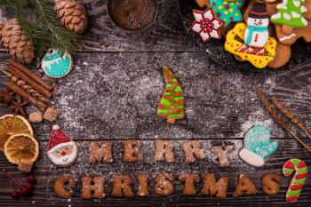 Gingerbreads and coffee for new years and christmas on wooden background, xmas theme