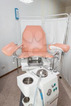 Gynecological cabinet with chair and other medical equipment in modern clinic