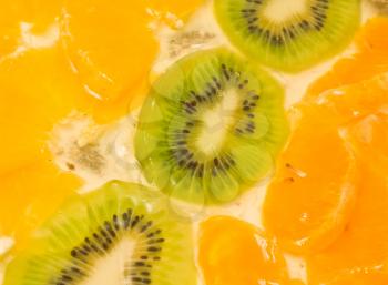 Fruit background. Sliced kiwi, orange and mandarin segments