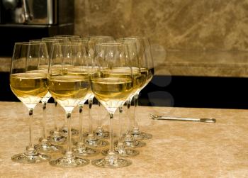 Glasses with white wine and opener on marble in the bar