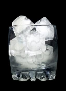 Refreshment: Glass with ice cubes over black background