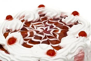 Tasty dessert - iced cake with cherries and beautiful red pattern