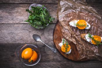 Bruschetta with cheese, tomatoes and salad rocket in rustic style. Food photo