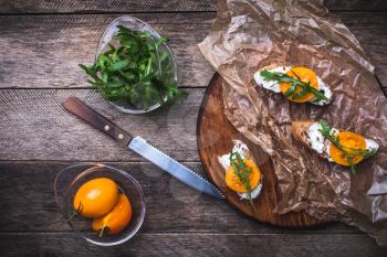 rustic style Bruschetta snacks with tomatoes and salad rocket . Food photo