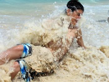 Boy swept by a caribbean surf wave.