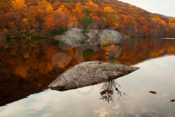 Beautiful fall colors reflecting in the forest lake.