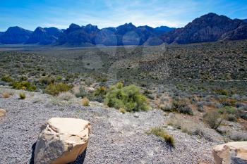 View of dry landscape and rock formations of the Mojave Desert.
