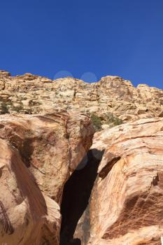 View of dry landscape and red rock formations of the Red Rock Canyon in the Mojave Desert.